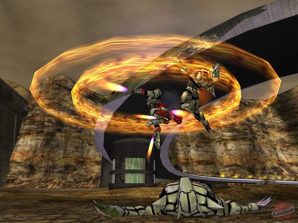 Two robots clash inside a ring of fire in a canyon arena